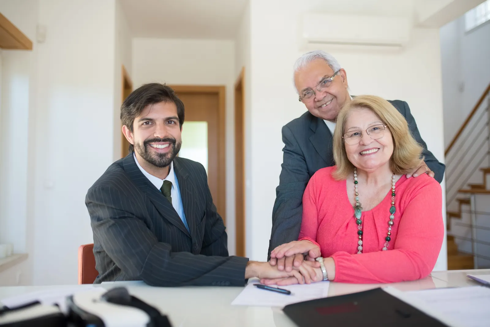A professional meeting with an older couple in a bright office