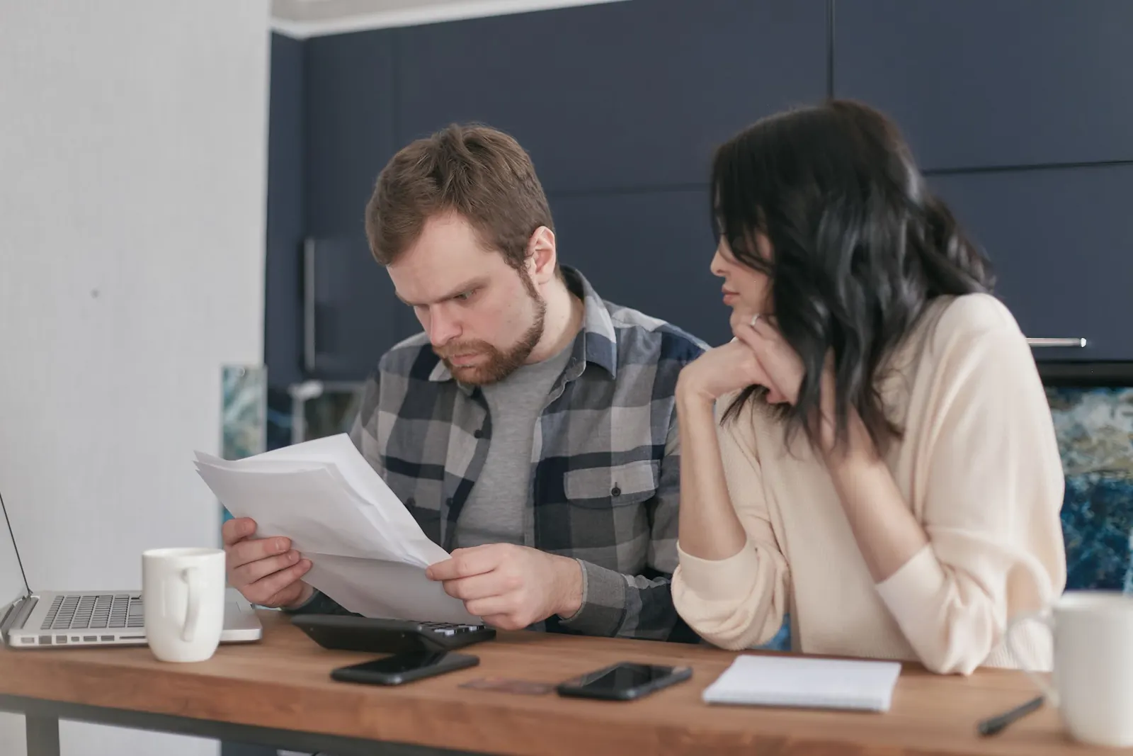 Two adults calmly reviewing papers at a bright dining table